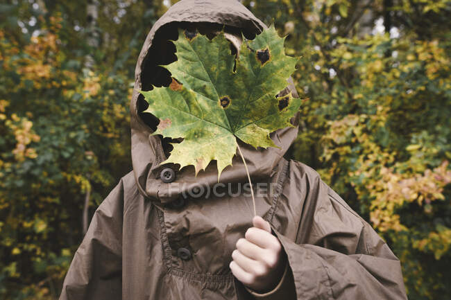 boy hiding his face