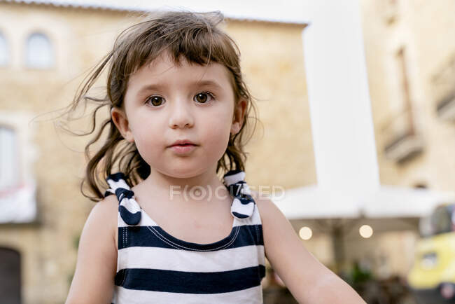 Ritratto di graziosa bambina in estate con indosso un vestito a righe — Foto stock