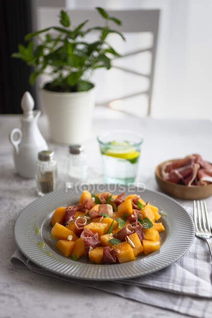 High angle view of melon salad served in plate on table — Stock Photo