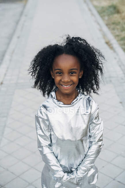 Portrait of happy little girl wearing space suit outdoors — Stock Photo