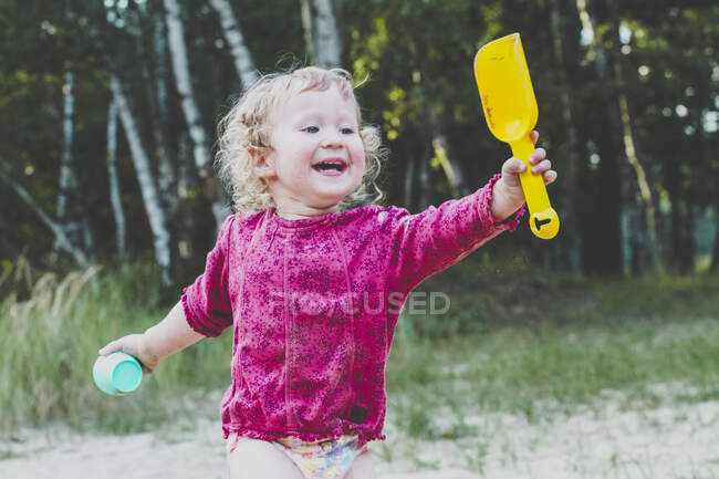 Portrait of happy toddler girl with sandbox toys — Stock Photo