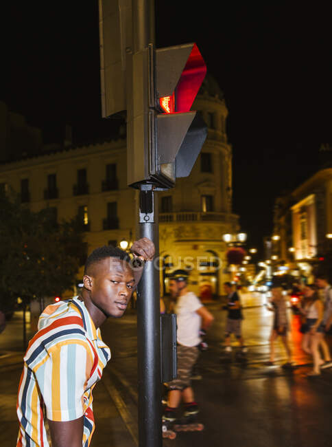 Portrait of cool young man on a steet at night in the city — Stock Photo