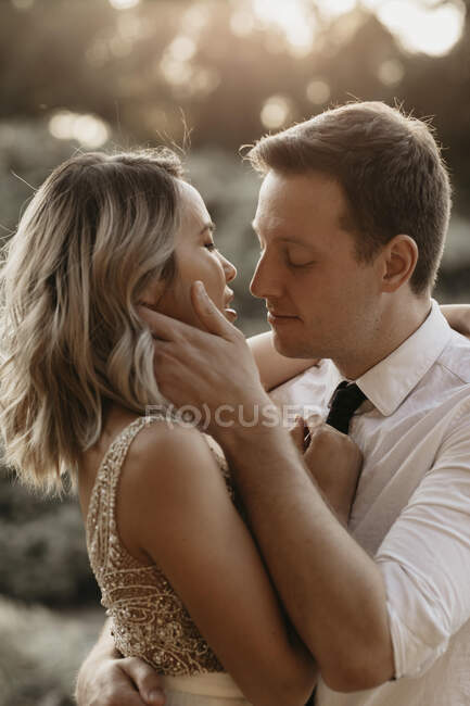 Passionate bride and groom kissing outdoors — Stock Photo