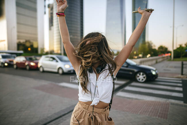 Девушка танцует, небоскребы на заднем плане — стоковое фото
