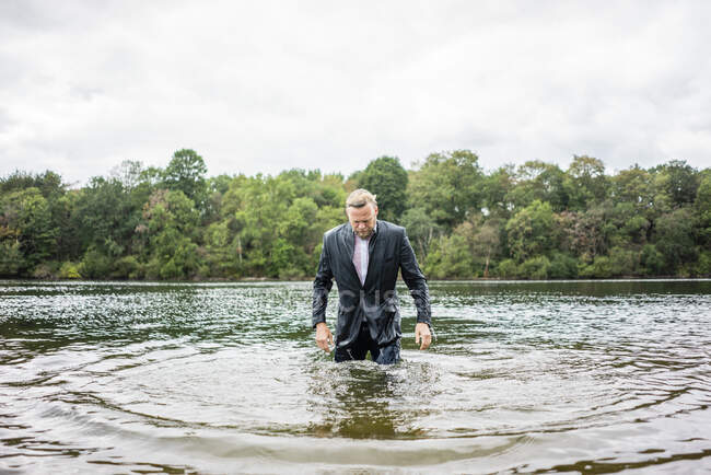 Homem de negócios molhado em um lago — Fotografia de Stock
