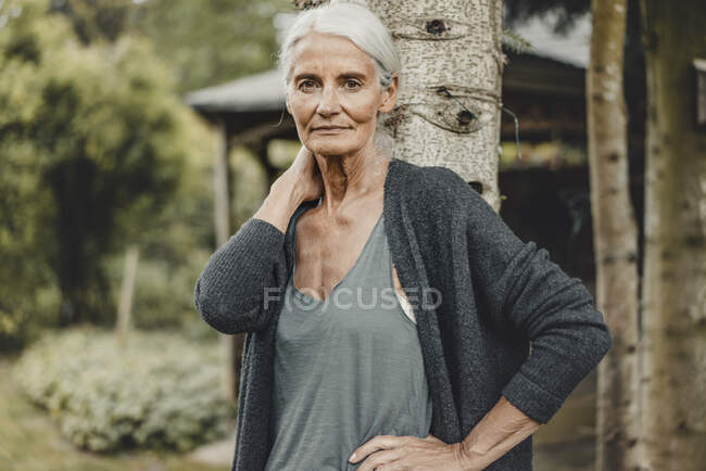 Senior woman standing in nature, portrait — Stock Photo