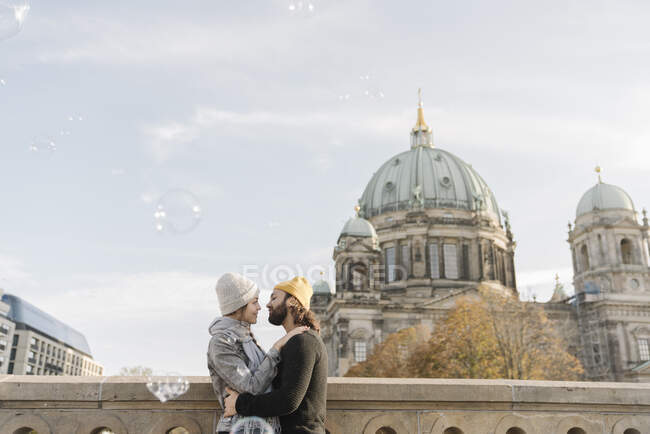 Young couple embracing with Berlin Cathedral in background, Berlin, Germany — Stock Photo