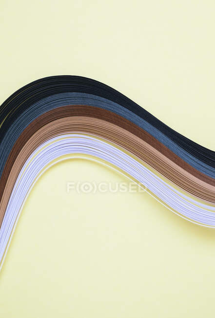 High angle view of multi colored art papers on beige background — Stock Photo