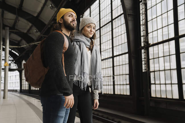 Young couple waiting at the station platform, Berlin, Germany — Stock Photo