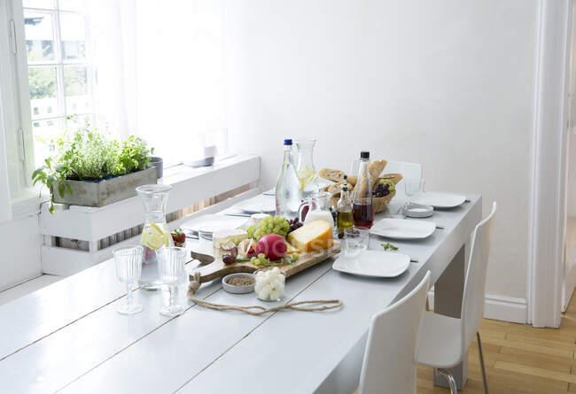 Table dressée avec fruits, fromage et pain — Photo de stock