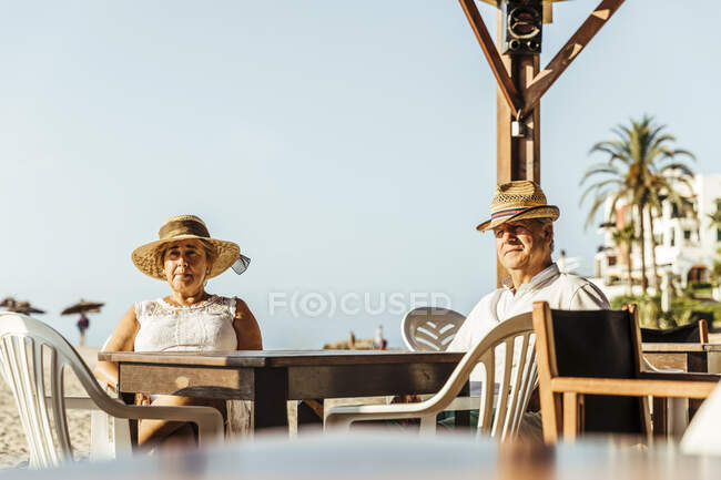 Coppia di anziani seduta in un bar terrazza sulla spiaggia, El Roc de Sant Gaieta, Spagna — Foto stock