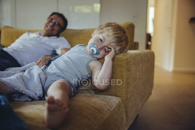 Little boy with pacifier, lying on couch, sleeping — Stock Photo