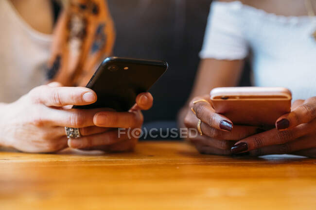 Multicultural women using smartphone — Stock Photo
