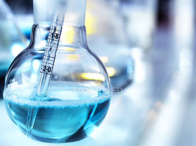 Close-up of pipette in flask on table at laboratory — Stock Photo