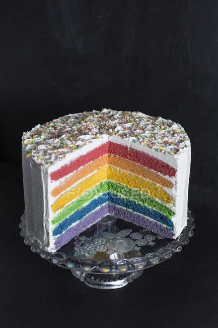 Close-up of rainbow cake against wall in studio — Stock Photo
