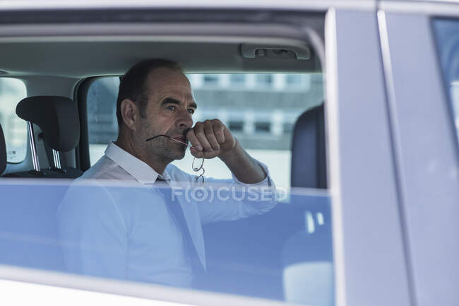 Portrait of thoughtful mature businessman in car — Stock Photo