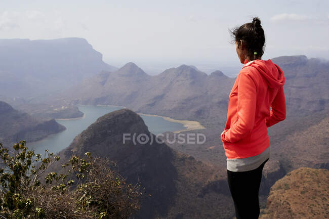 Frau steht auf einem Hügel und genießt die wunderschöne Landschaft unter sich, Blyde River Canyon, Südafrika. — Stockfoto