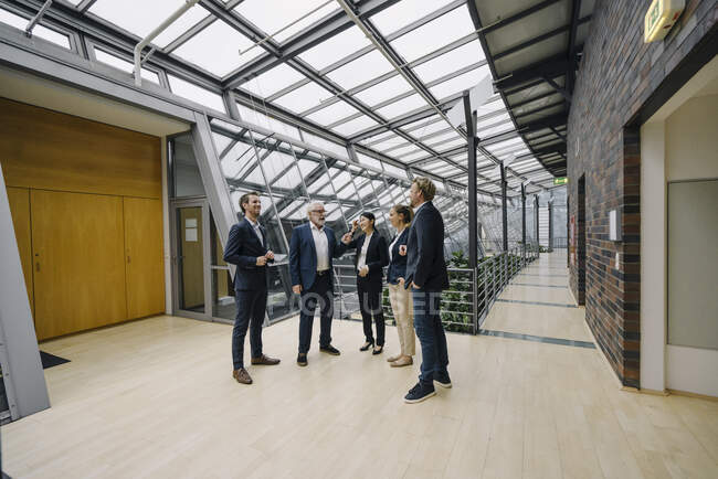 Confident business people talking in modern office building — Stock Photo