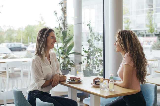 Junge Studenten genießen Kuchen im Café — Stockfoto