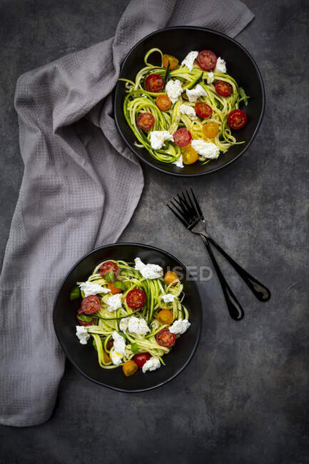 Direttamente sopra colpo di insalata vegetale servita in ciotole con forchette e tovagliolo sul tavolo — Foto stock