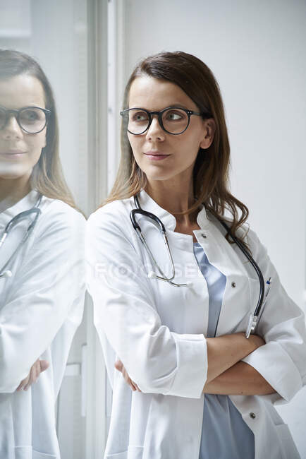 Portrait of confident female doctor at the window — Stock Photo