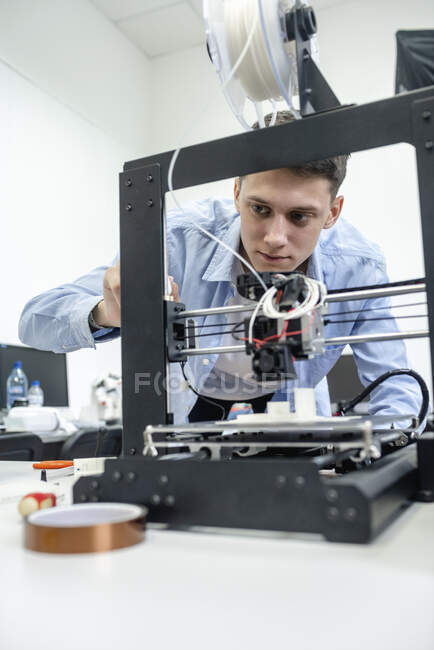 Student richtet mit Laptop 3D-Drucker ein — Stockfoto