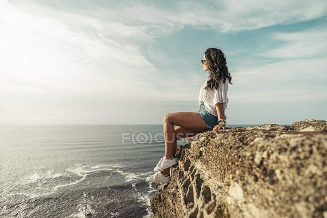 Young woman sitting on viewpoint and looking at distance, Getxo, Spain — Stock Photo