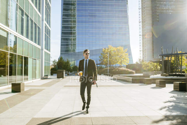 Confident businessman walking in urban business district, Madrid, Spain — Stock Photo