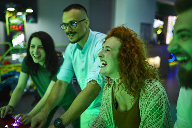 Amici felici che giocano e si divertono in una sala giochi di divertimento — Foto stock