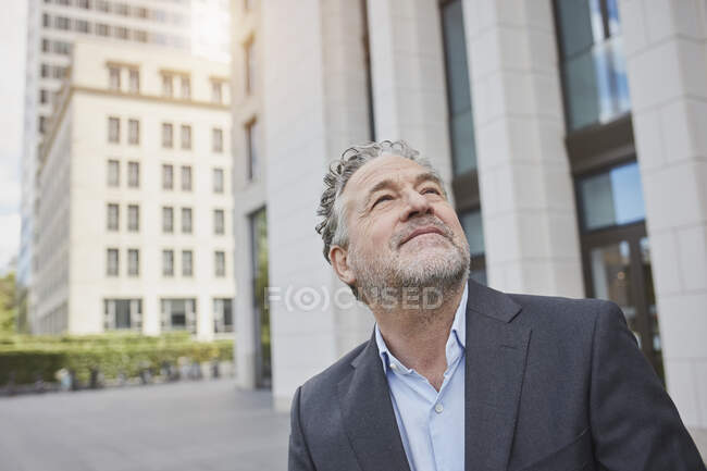Portrait d'un homme d'affaires confiant dans la ville levant les yeux — Photo de stock