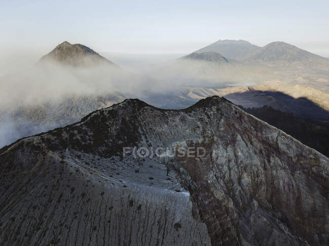 Indonésia, Java, Vista aérea de fumaça flutuando sobre as montanhas ao redor do vulcão Ijen — Fotografia de Stock