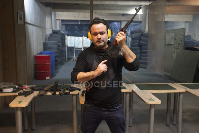Portrait of a man with a gun in shooting range — Stock Photo
