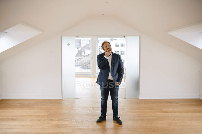 Businessman standing in empty apartement looking around — Stock Photo