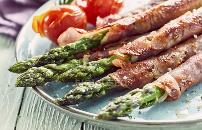 Plate of asparagus ham rolls — Stock Photo