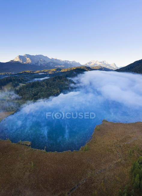 Germany, Bavaria, Krun, Drone view of Barmsee lake shrouded in thick fog — Stock Photo