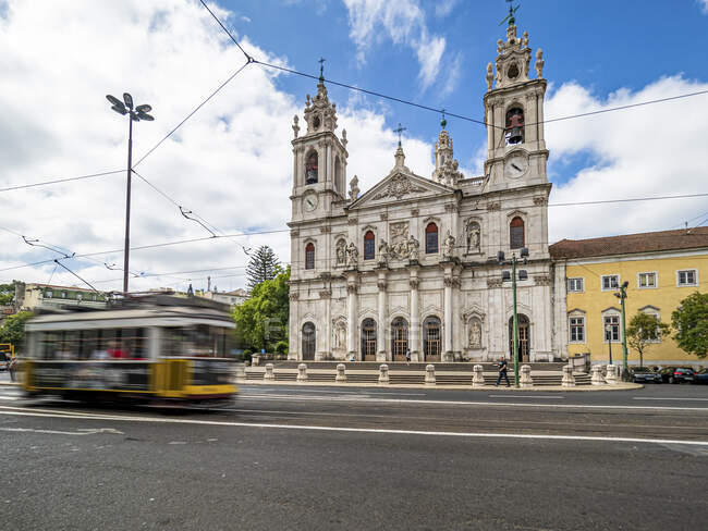 Portugal, Lisbon, Facade of Estrela Basilica with tram in foreground — Stock Photo
