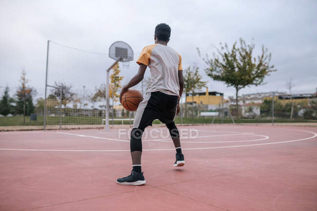African american Teenager playing basketball — Stock Photo