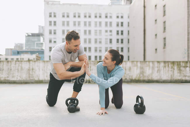 Man and woman high five while exercising in the city, Vancouver, Canada — Stock Photo