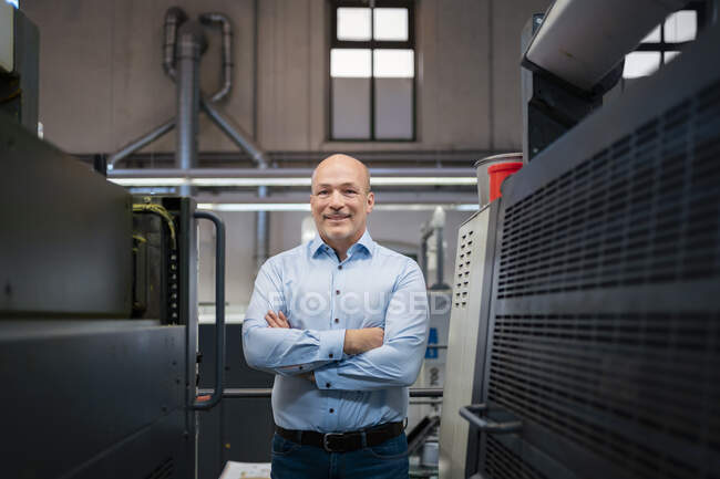 Portrait of a confident businessman in a factory — Stock Photo
