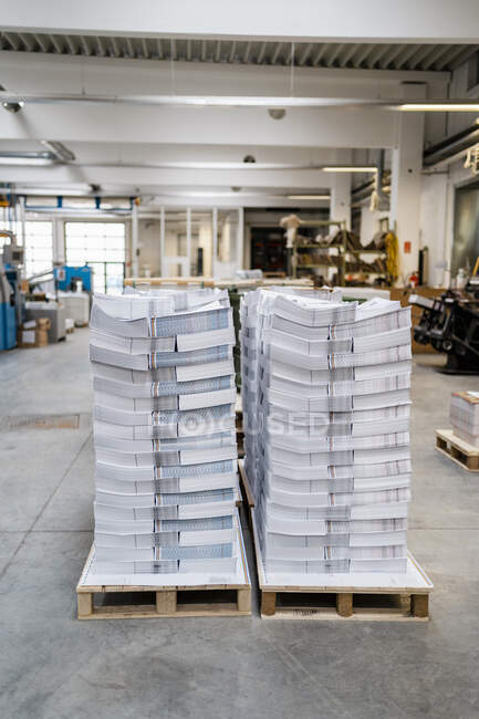 Stacks of papers on pallets in a printing shop — Stock Photo