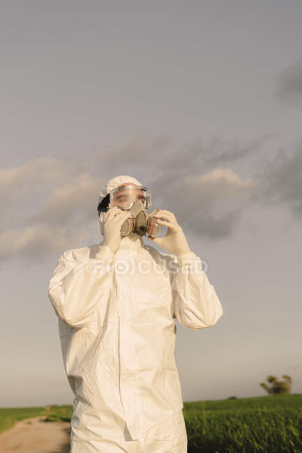 Man wearing protective suit and mask in the countryside — Stock Photo