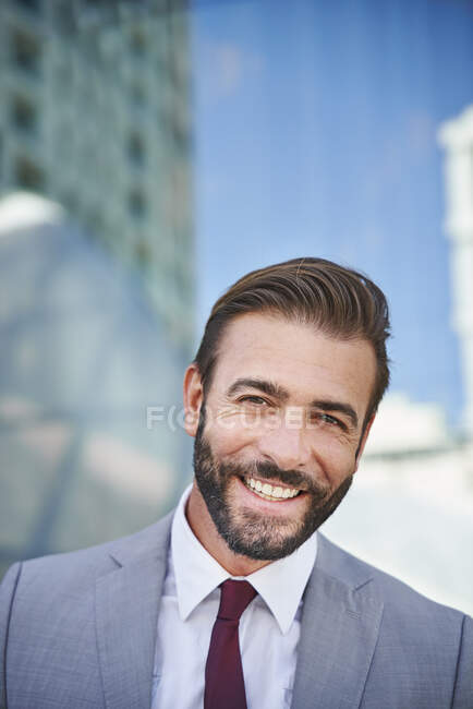 Portrait of happy businessman in the city — Stock Photo