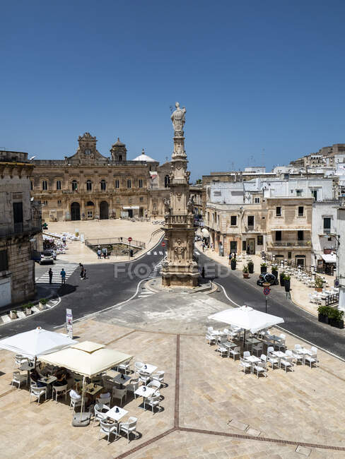 Italy, Province of Brindisi, Ostuni, Clear sky over town square and Spire of SantOronzo — Stock Photo