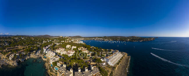 Spain, Balearic Islands, Costa de la Calma, Aerial panorama of clear blue sky over coastal town in summer — Stock Photo