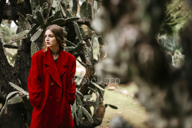 Woman with red coat in a park — Stock Photo