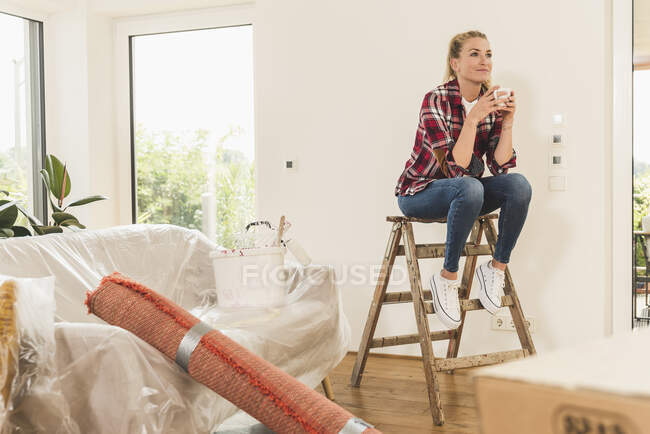 Femme emménageant dans une nouvelle maison prendre une pause café — Photo de stock
