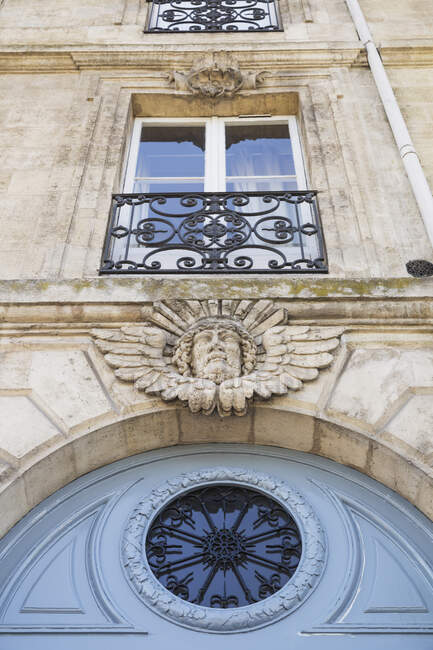 Francia, Gironda, Bordeaux, Vista di angolo basso del mascaron che decora l'entrata dell'edificio residenziale — Foto stock