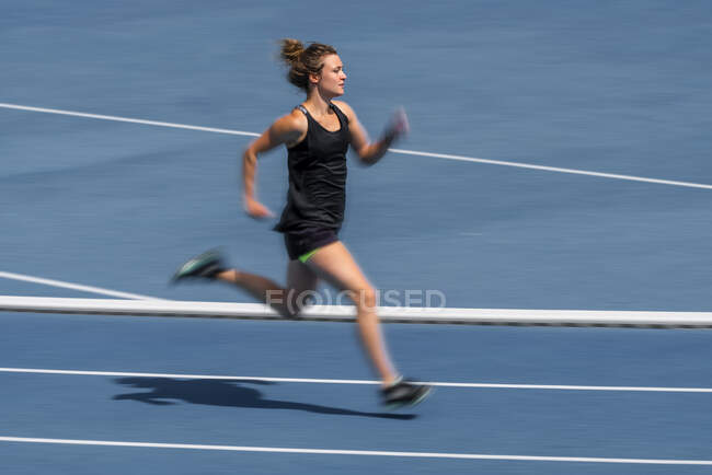 Female runner on tartan track — Stock Photo