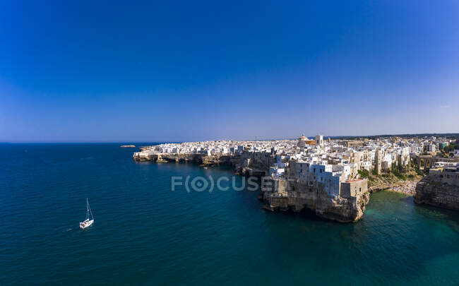 Italy, Polignano a Mare, Clear blue sky over coastal town in summer — Stock Photo