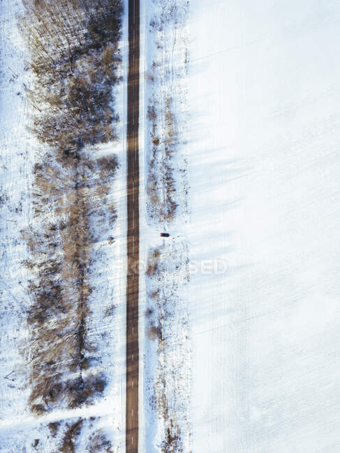 Russia, Moscow Oblast, Aerial view of car driving into snow-covered field — Stock Photo